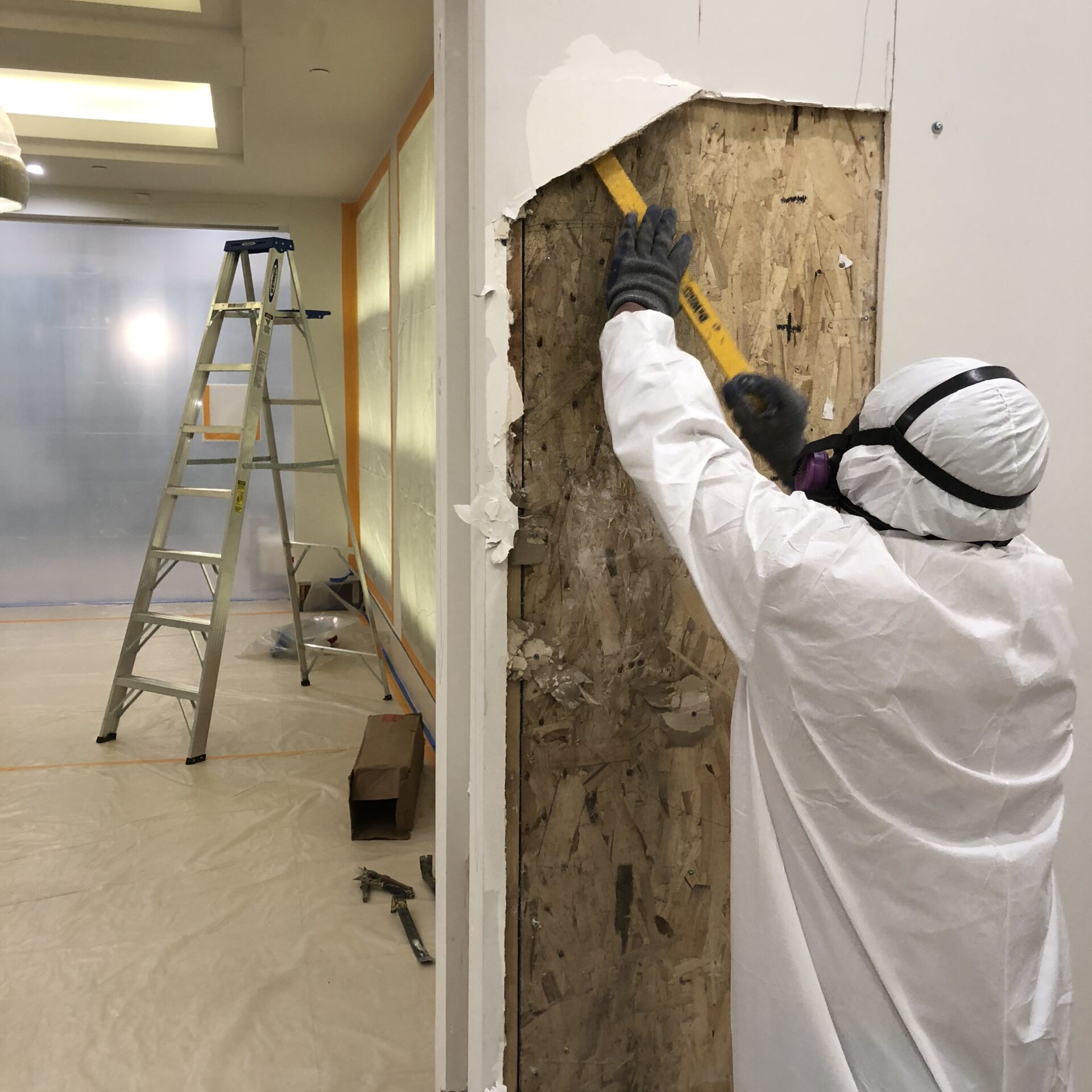 Mold removal specialists from Orange County removing damaged drywall.