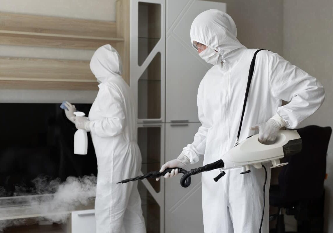 Professional mold removal specialists from Mold Fix Inc. spraying disinfectors around the house.